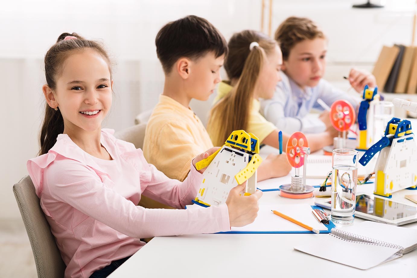 Stem education. Girl creating robot at lab